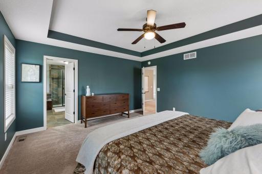 Luxurious primary with sunset views over nature area