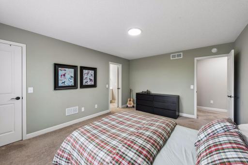 This bedroom features an attached walk-though bathroom.