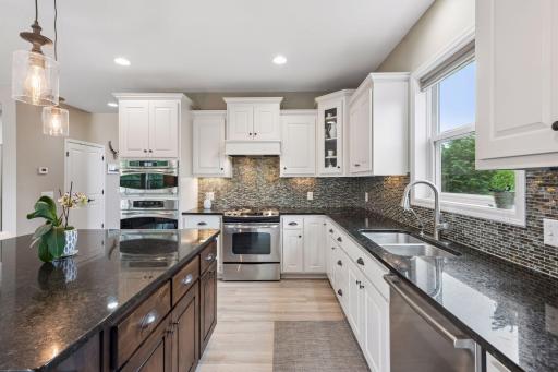 Kitchen features stainless appliances (wall oven + separate gas range) and granite countertops.