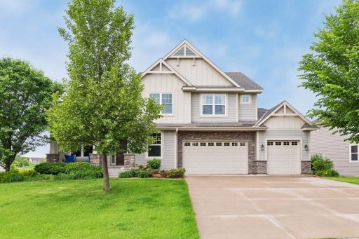 Impressive curb appeal welcomes guests with an inviting front porch and concrete driveway.