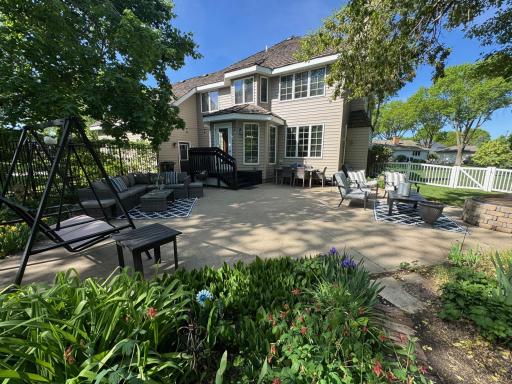 The patio is surrounded by beautiful landscaping