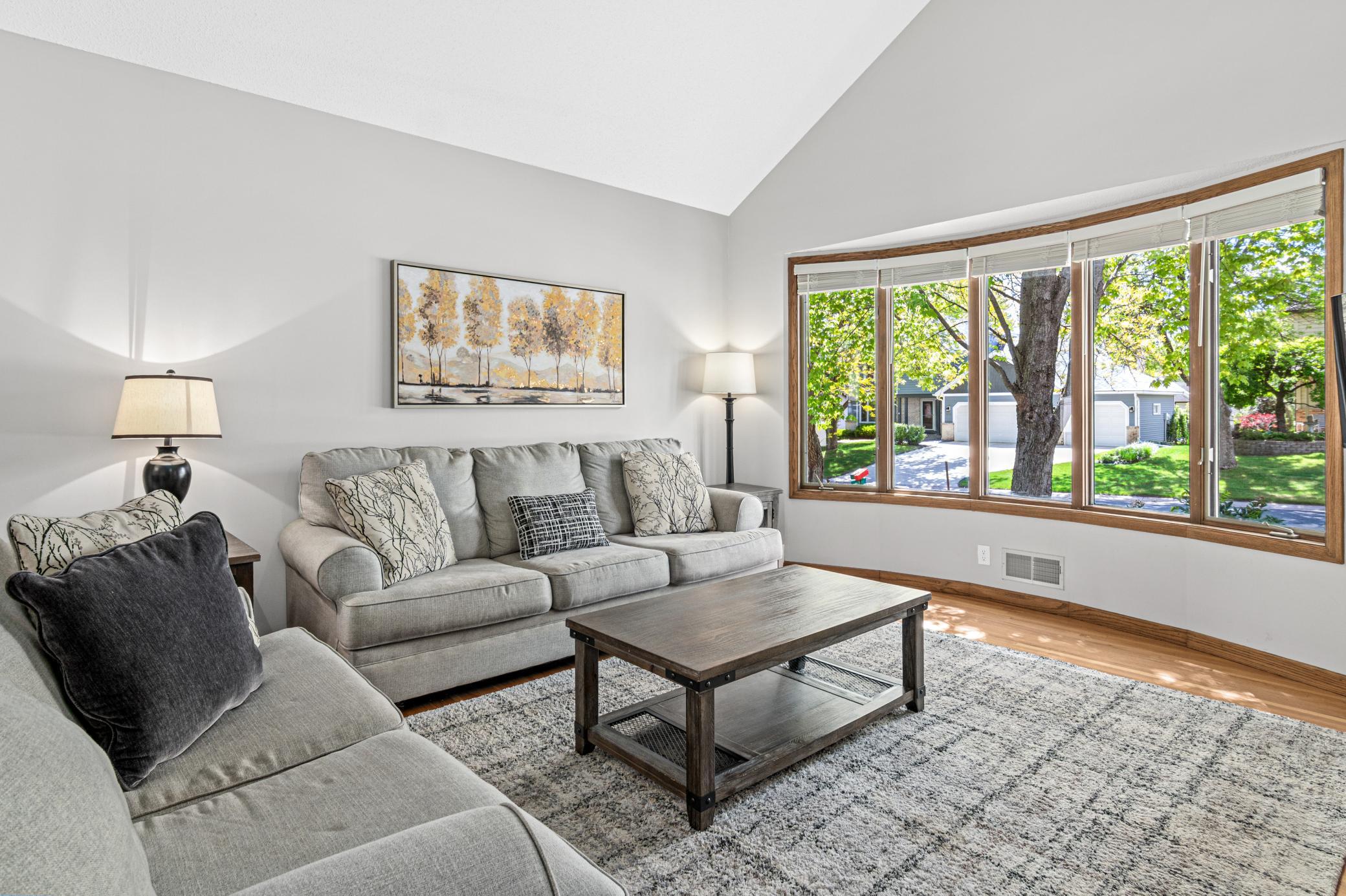Living room with large window and beautiful hard wood floors