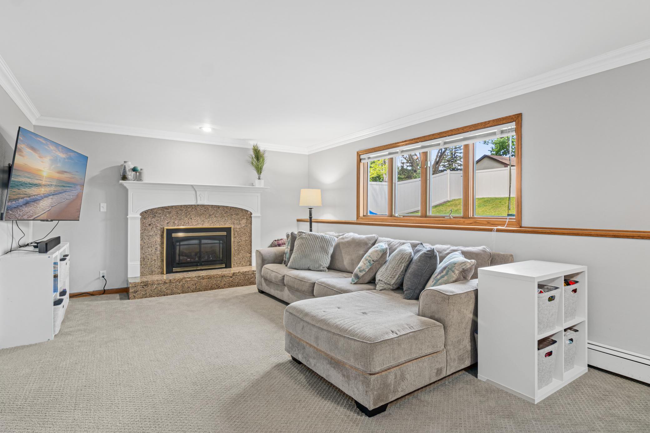Lower level family room with cozy gas fireplace.