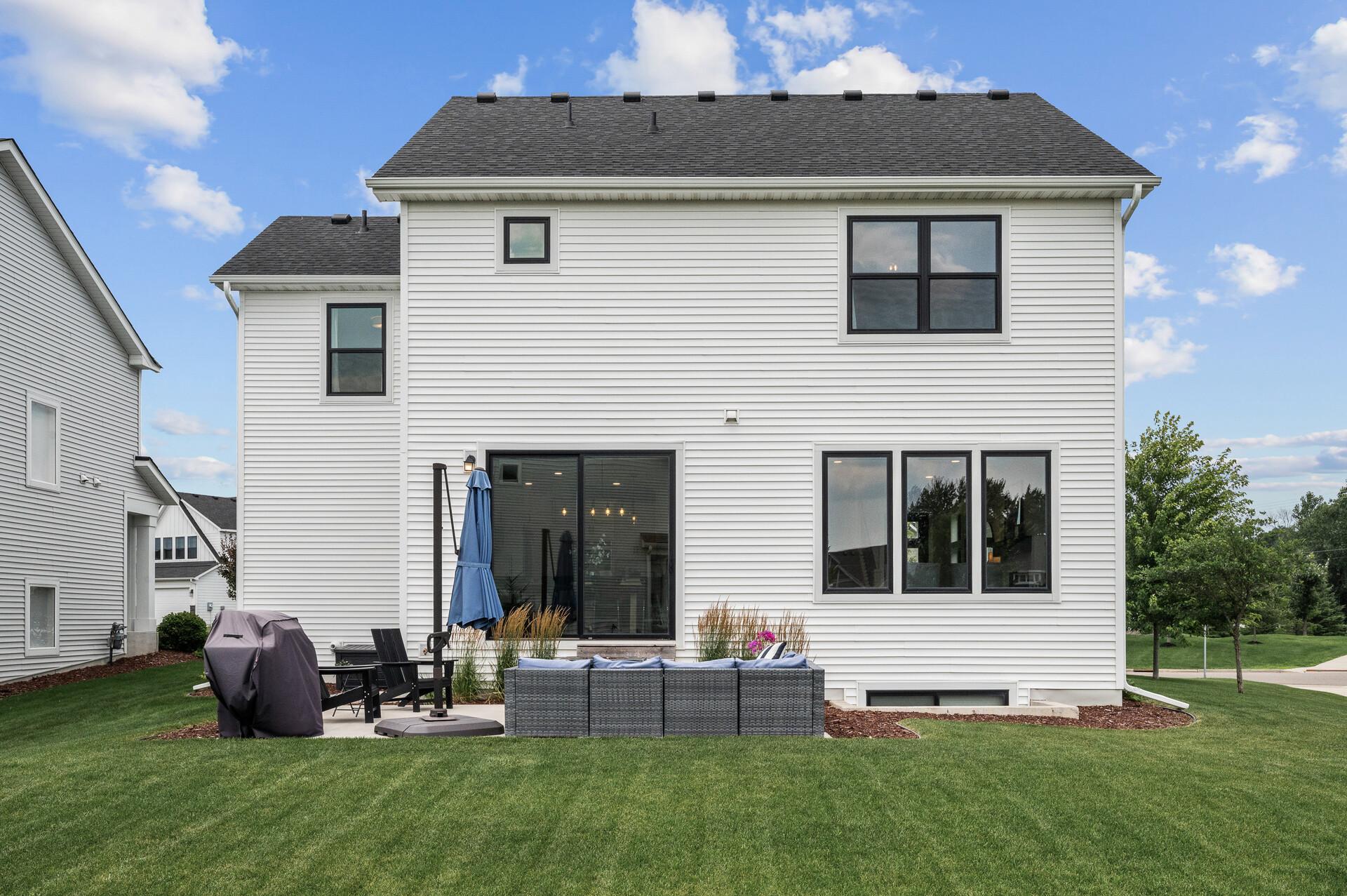 Smart looking home with big windows and large sliding door.
