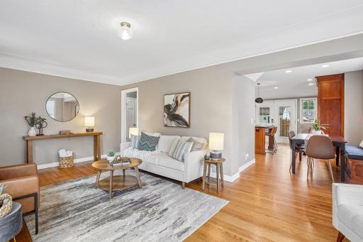 An open floor plan creates a natural flow, connecting the living room and sitting area seamlessly with the dining and kitchen spaces