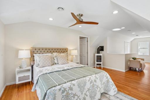 The tranquil primary bedroom includes a beautiful, functional JÃ¸tul gas stove, providing efficient zone heating and a cozy ambiance