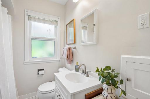 The main-floor full bath is conveniently situated between the two bedrooms, offering an ideal layout for guests or daily living