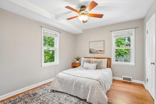 Overlooking the backyard, the second main floor bedroom provides a quiet space separate from the main living areas