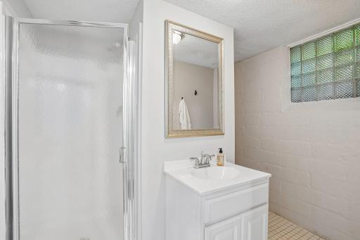 A convenient lower-level three-quarter bath perfectly services both the recreation room and the adjacent fourth bedroom