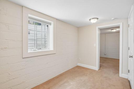 A versatile fourth bedroom off the lower-level recreation room features a newly installed full egress window, making it ideal for a guest suite, yoga/exercise studio, or private home office