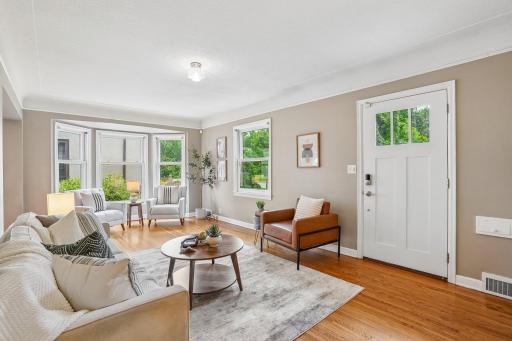 Inside, open spaces, gleaming hardwood floors, and bright, cheerful light immediately draw you in