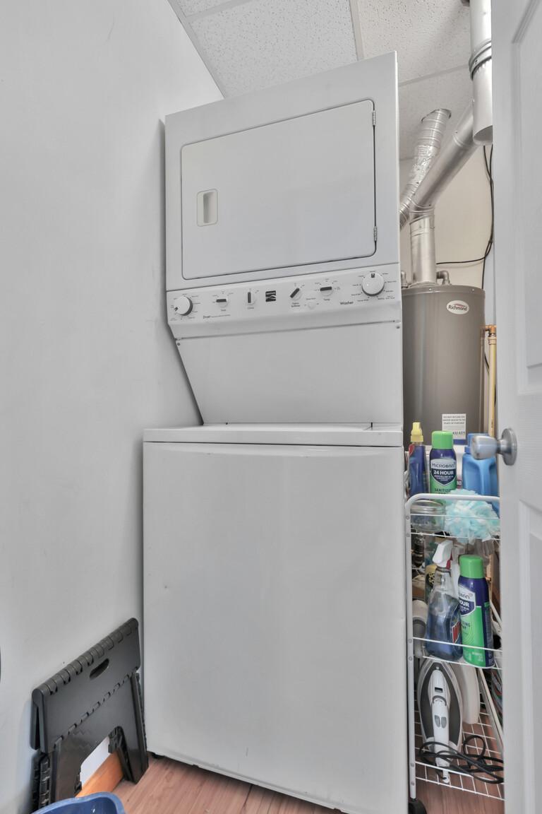 Stacked washer and dryer, in mechanical room. New furnace and AC unit.