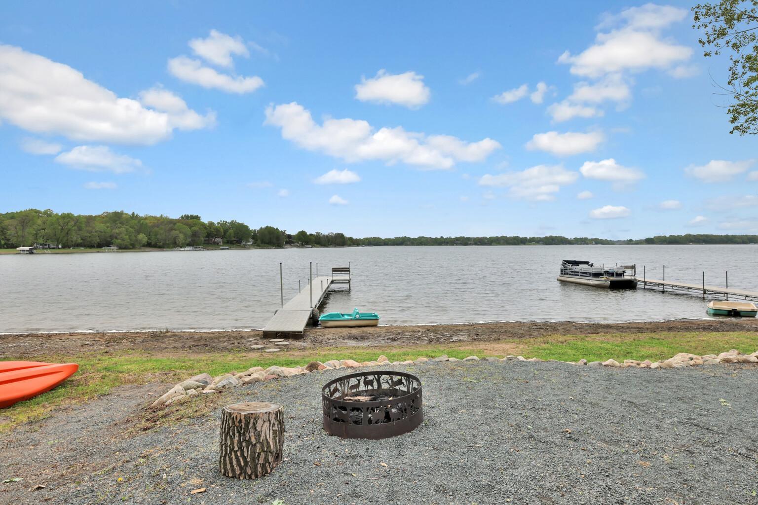 Fire ring for evening roasts, stone retaining wall and sandy beach for swimming enjoyment.