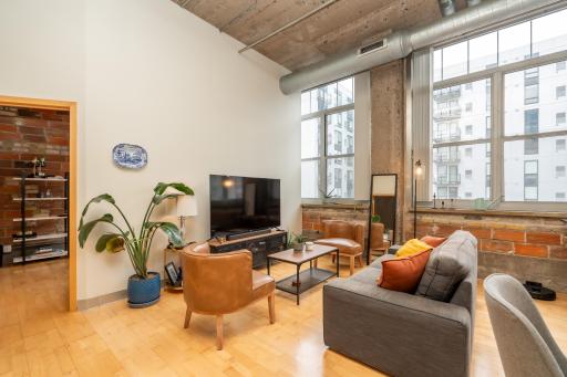 Flexible open living area easily accommodates a home office, lounge seating, and dining space without feeling crowded