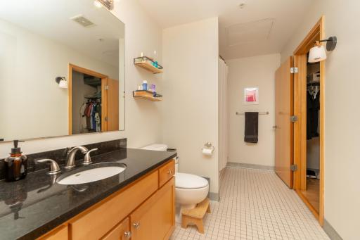 Bathroom features granite countertops, oversized vanity space, and modern finishes