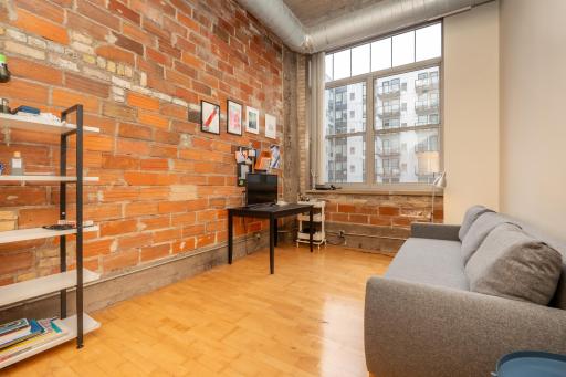 Bedroom #2 - continues with the industrial look with hardwood flooring and this beautiful tall window