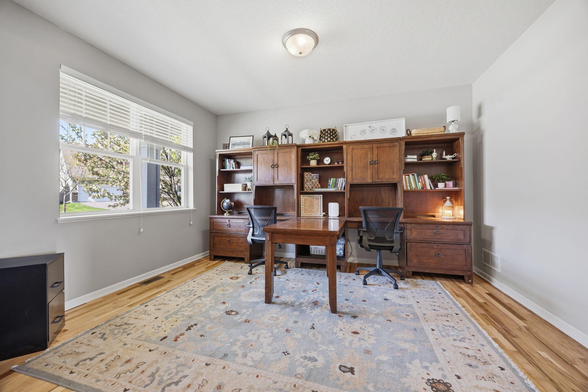 Versatile main-level office or flex room with large sun-filled window, ideal for working from home, studying, or creating a quiet retreat.