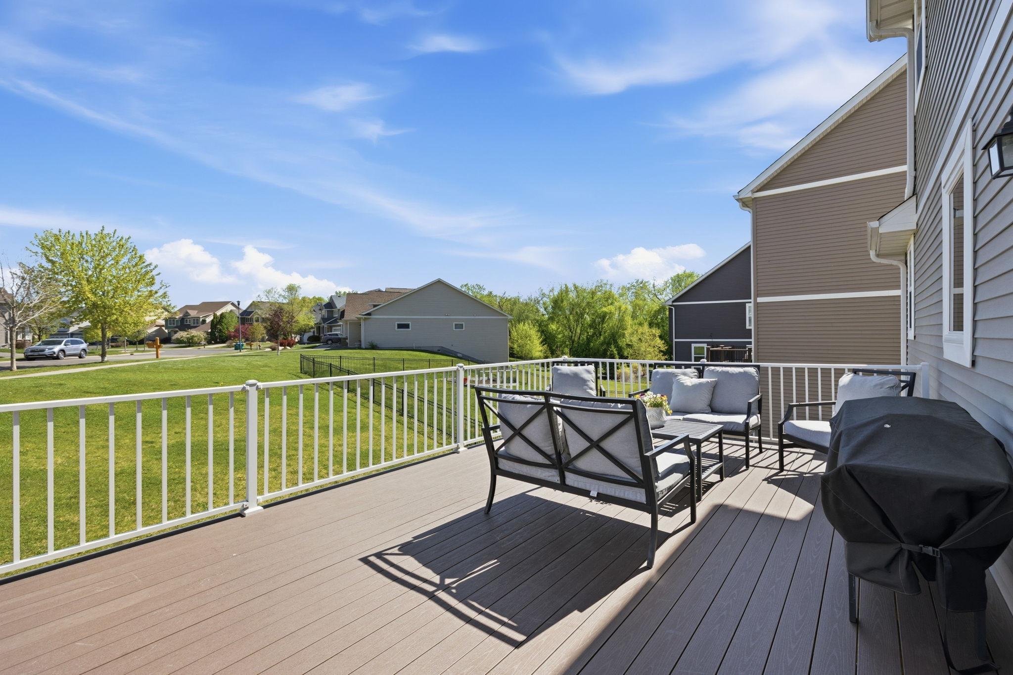 Expansive maintenance-free deck overlooking the spacious yard, offering the perfect outdoor setting for relaxing, grilling, and entertaining guests.