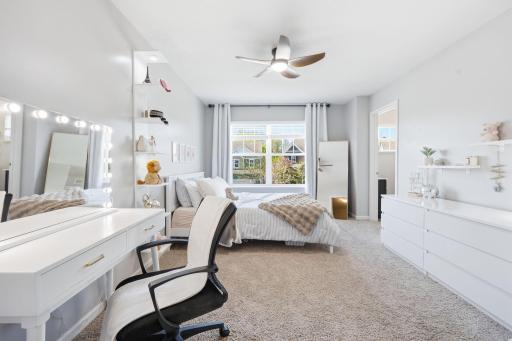 Spacious secondary bedroom with large picture window, plush carpeting, and flexible layout perfect for a bedroom, study space, or teen retreat.