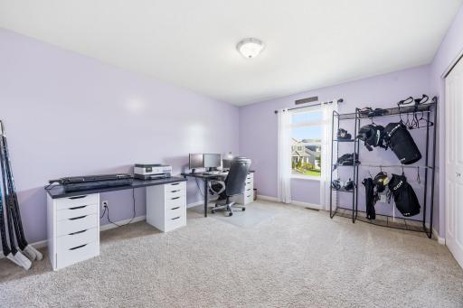 Generously sized upper-level bedroom with large window, plush carpeting, and flexible space ideal for a bedroom, gaming setup, home office, or workout area.
