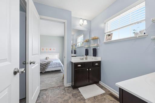 Convenient Jack-and-Jill style bathroom with dual access, oversized vanity, natural light, and functional layout designed for shared everyday living.