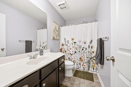Upper-level full bathroom with oversized vanity, tile flooring, and neutral finishes offering comfort, convenience, and plenty of space for family or guests