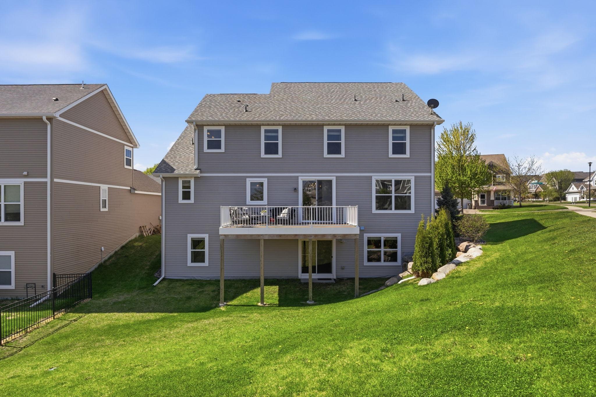 Walkout lower level and elevated maintenance-free deck overlook the spacious backyard, offering beautiful views and exceptional indoor-outdoor living potential.