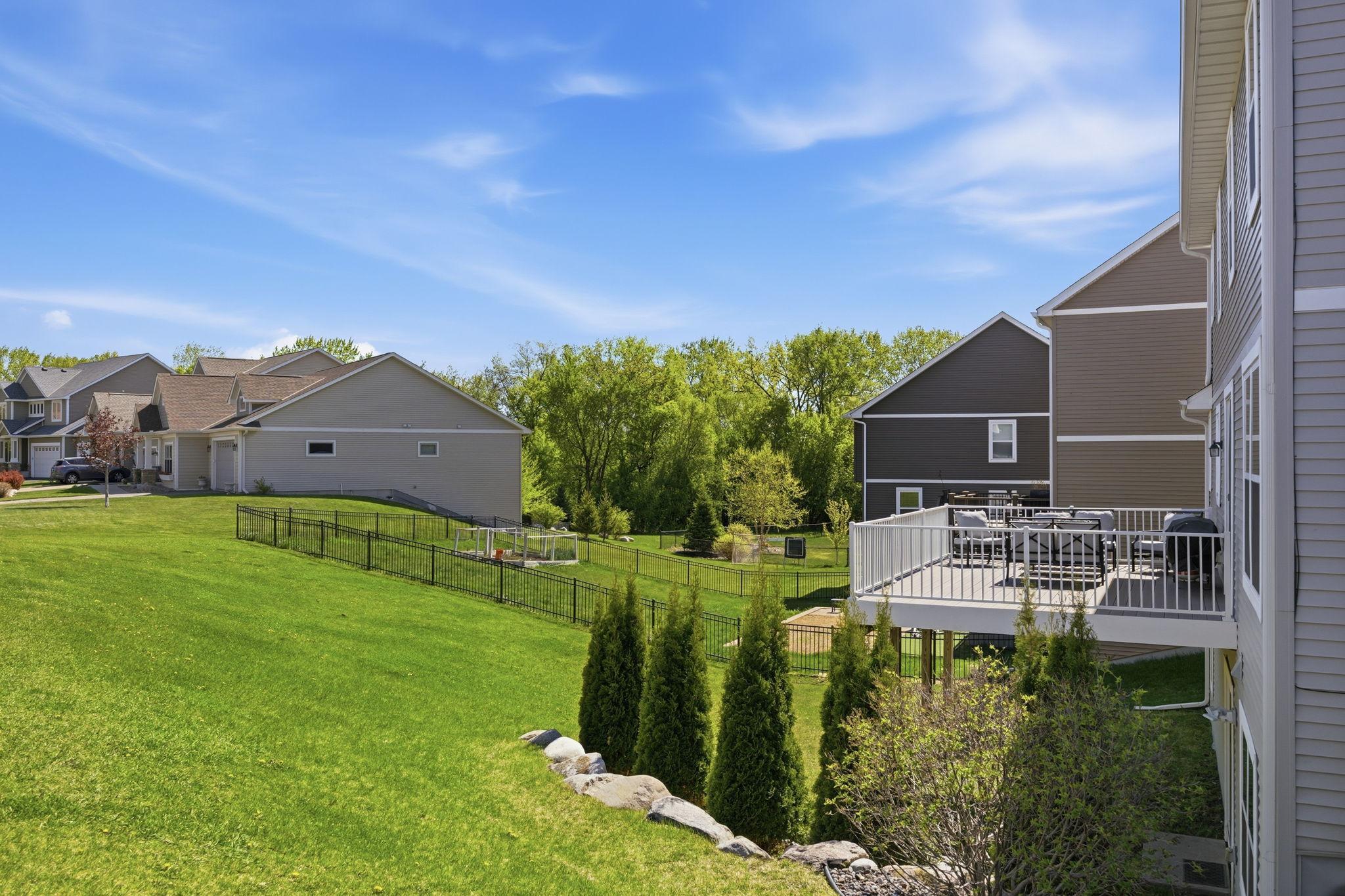 Enjoy peaceful backyard views from the elevated maintenance-free deck overlooking green space, mature trees, and beautifully landscaped surroundings.
