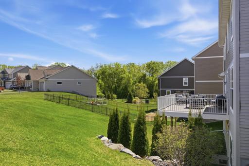 Enjoy peaceful backyard views from the elevated maintenance-free deck overlooking green space, mature trees, and beautifully landscaped surroundings.
