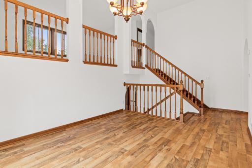 Beautiful curved archways going from the dining area to the stairways.
