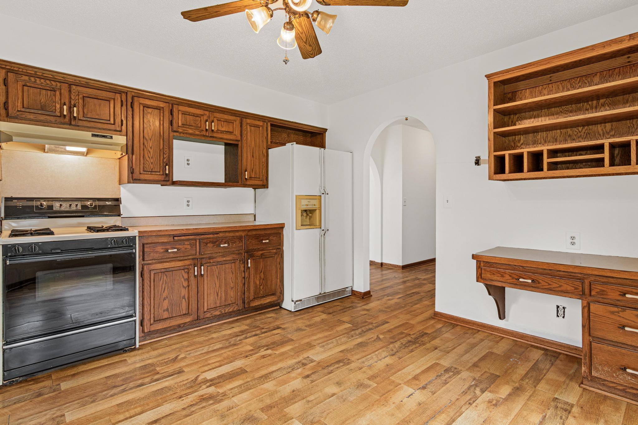 Another view of the kitchen towards the entry way with built in desk.
