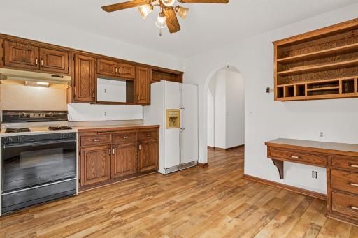 Another view of the kitchen towards the entry way with built in desk.