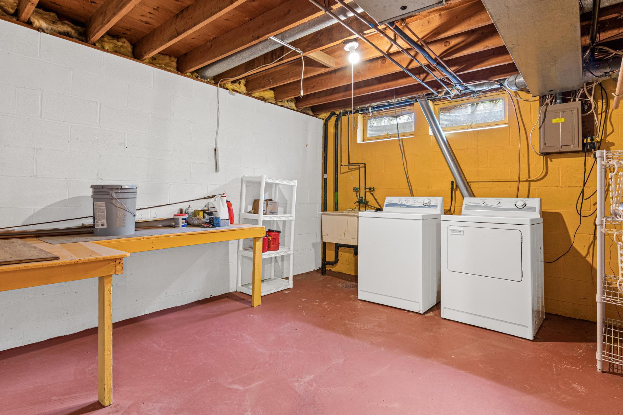 Basement laundry space with plenty of room for more storage!