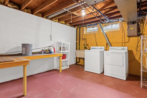 Basement laundry space with plenty of room for more storage!