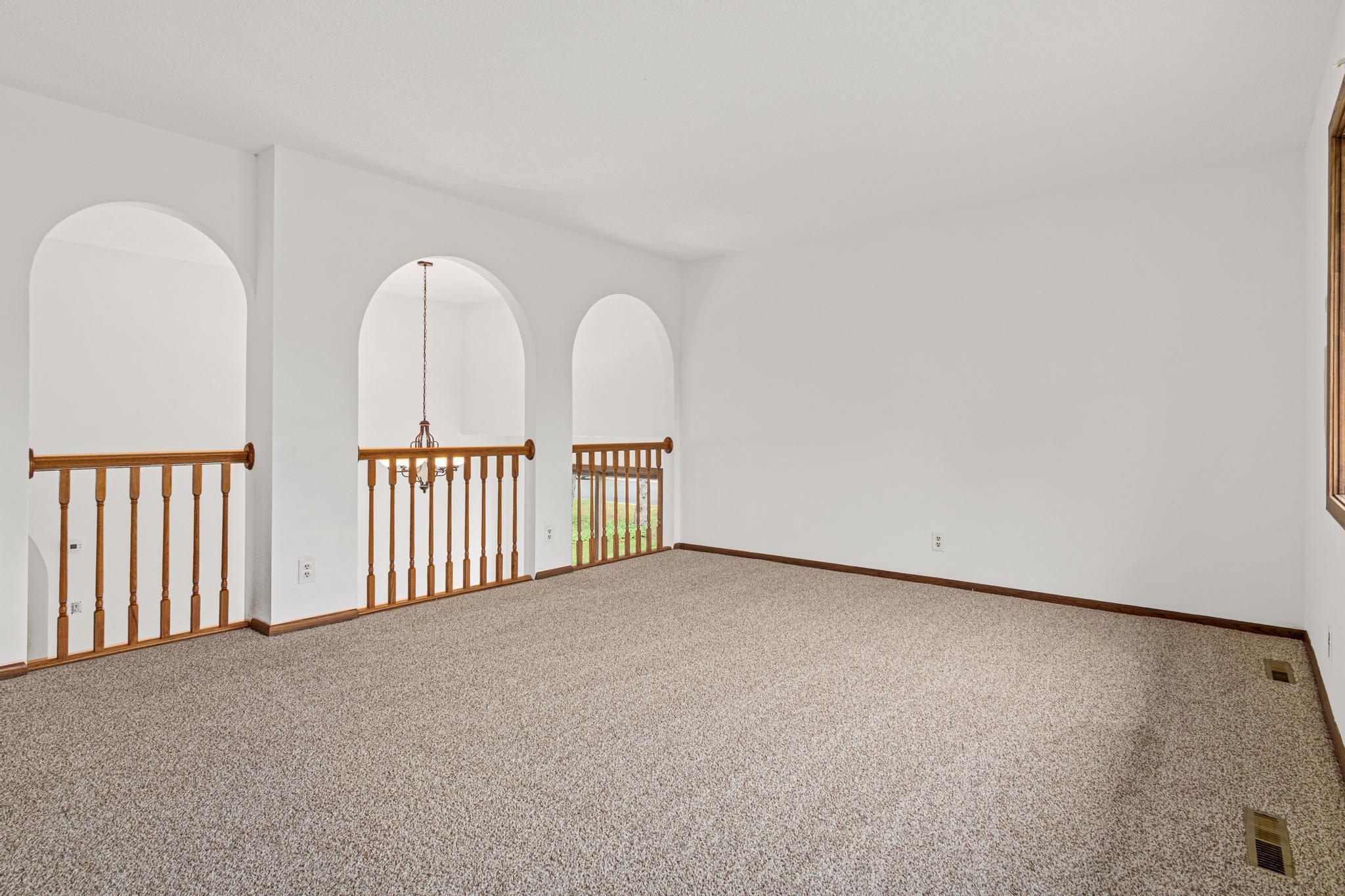Upper level living room with view of the beautiful archways.