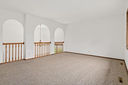 Upper level living room with view of the beautiful archways.