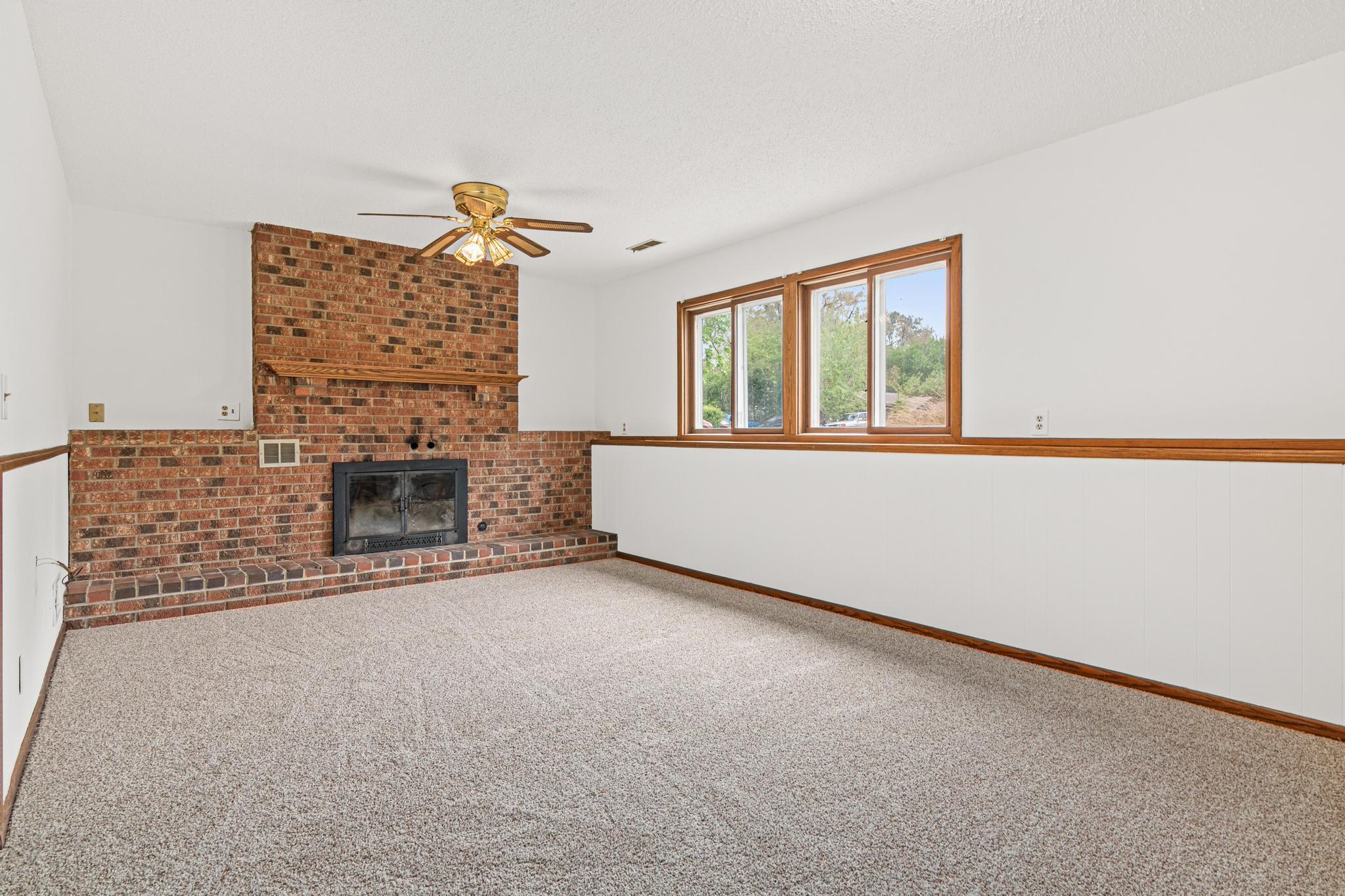 Down a level we have this massive family room with a wood burning fireplace.