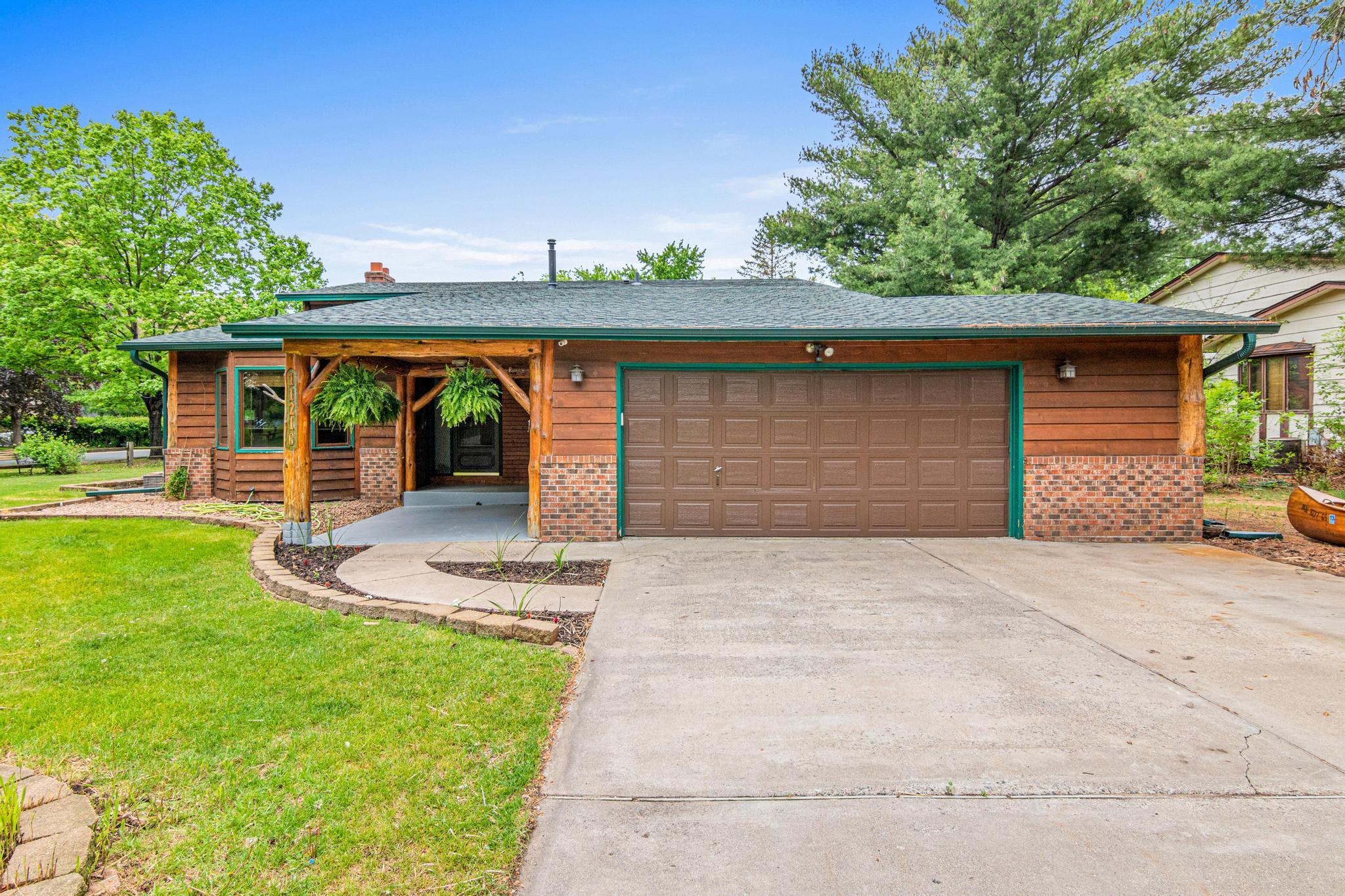 Extra wide concrete driveway with large front door patio space.