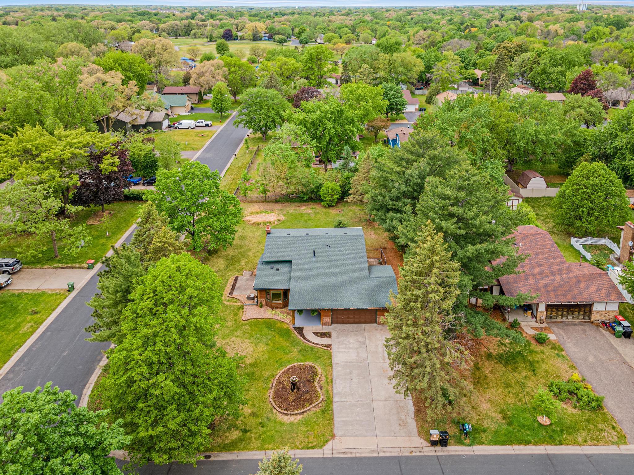 Front view of home with the wide driveway and landscaping waiting for your personal touch.
