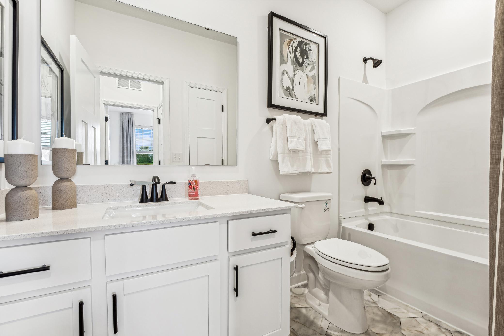 (Photo of a decorated model, actual homes finishes will vary) The secondary bath.