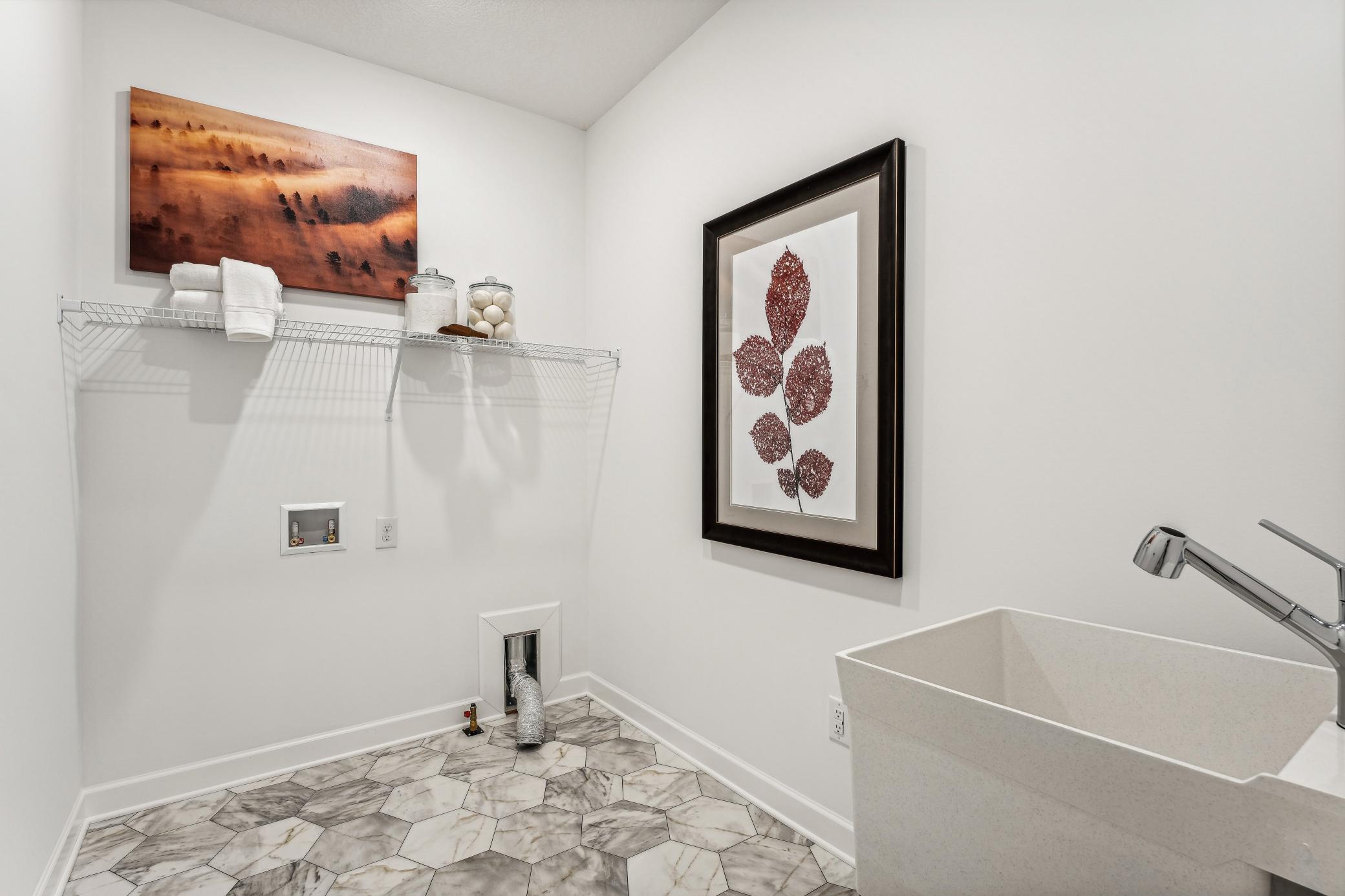(Photo of a decorated model, actual homes finishes will vary) The laundry room.