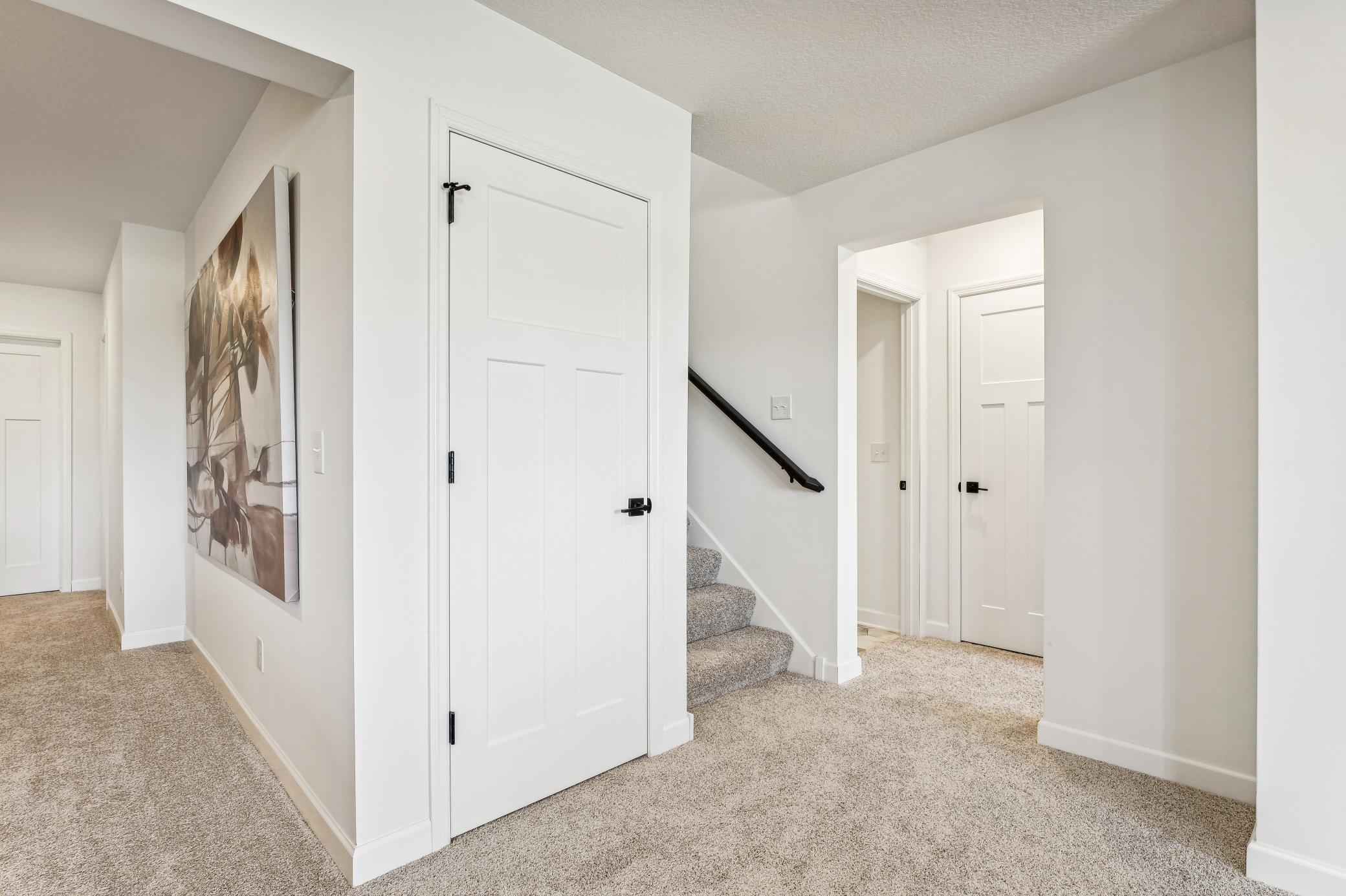 (Photo of a decorated model, actual homes finishes will vary) The stairs lead to the finished basement.