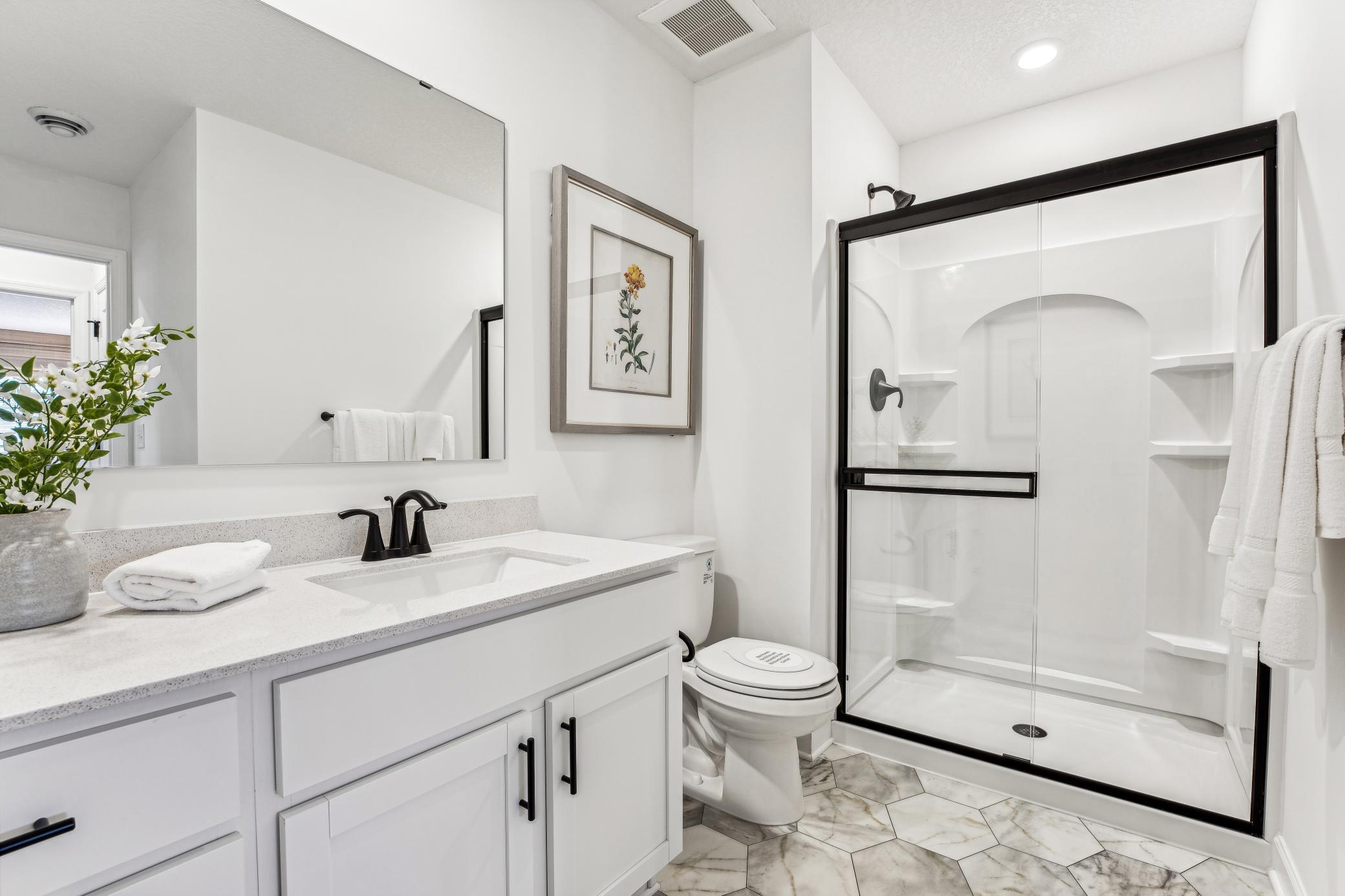 (Photo of a decorated model, actual homes finishes will vary) Lower-level bath.