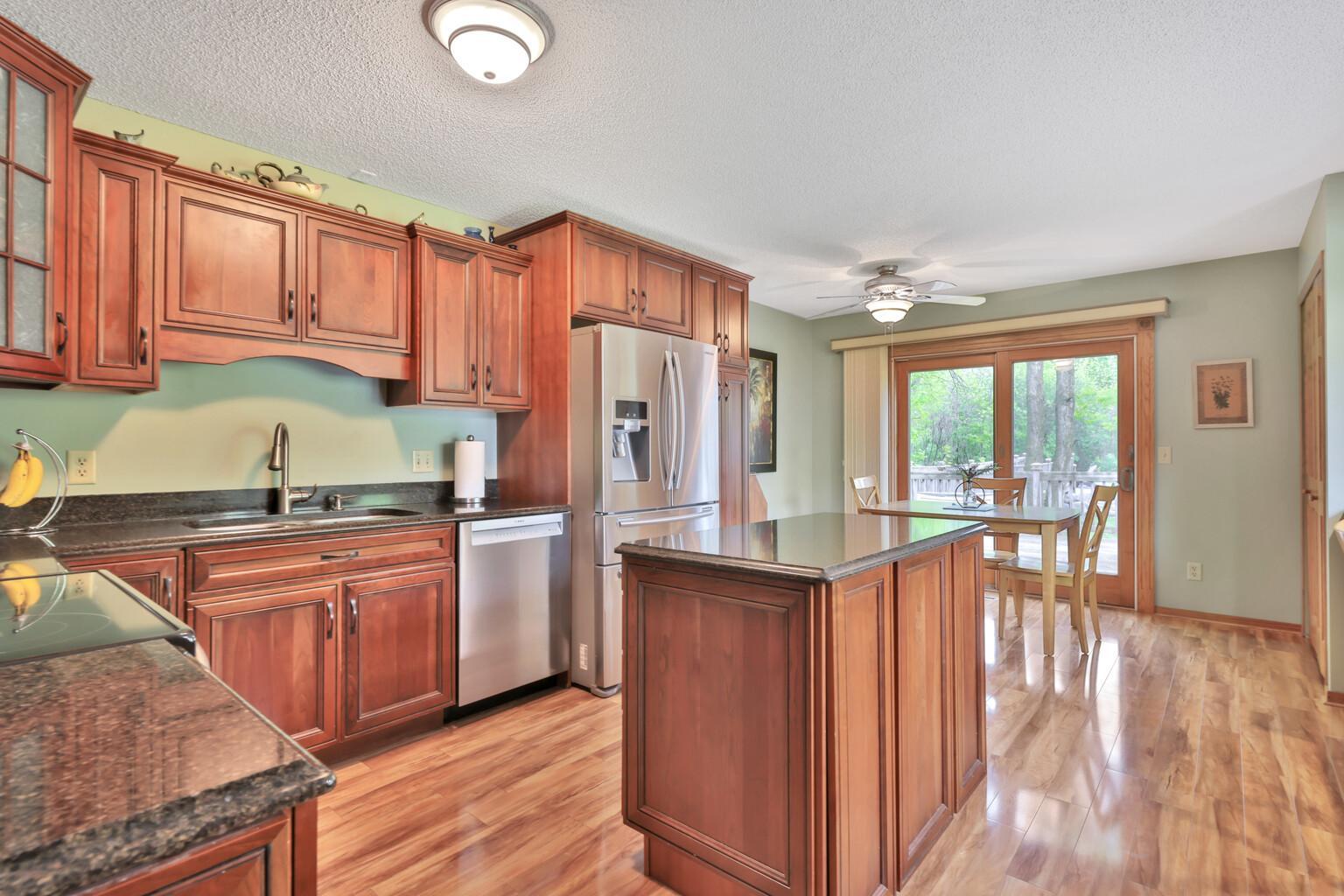 Spacious kitchen with Island - Quartz tops - Anderson Patio door out to the deck