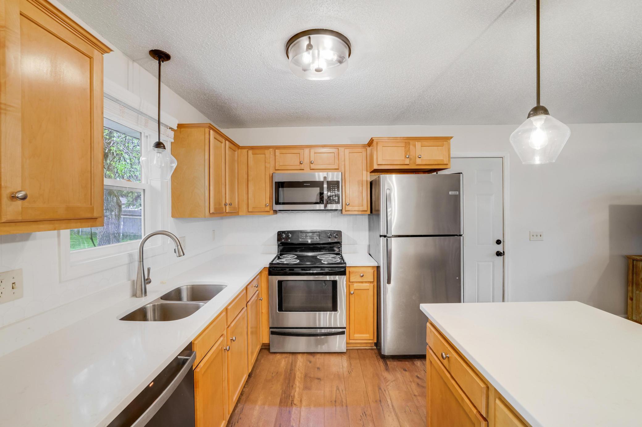 Plenty of Maple cabinetry, quartz countertops and stainless steel appliances