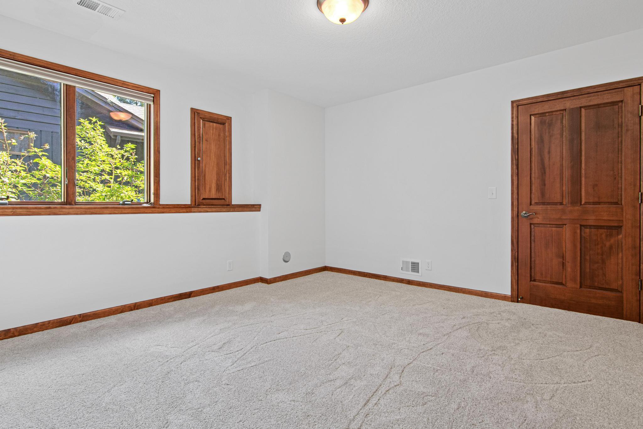 Second bedroom in the basement with a large closet for storage.