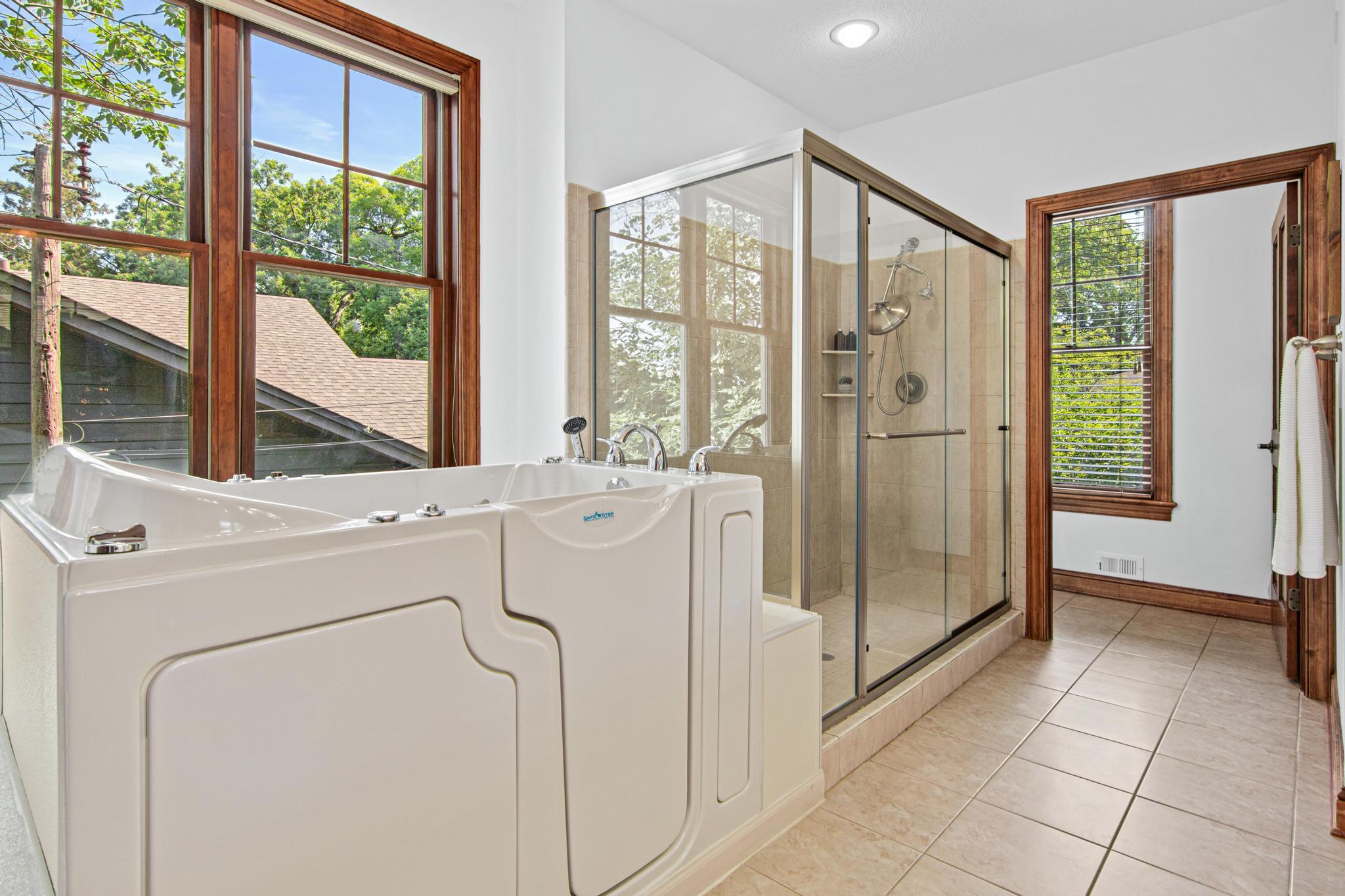 Primary bathroom with a walk in shower, and walk in tub for convenience.