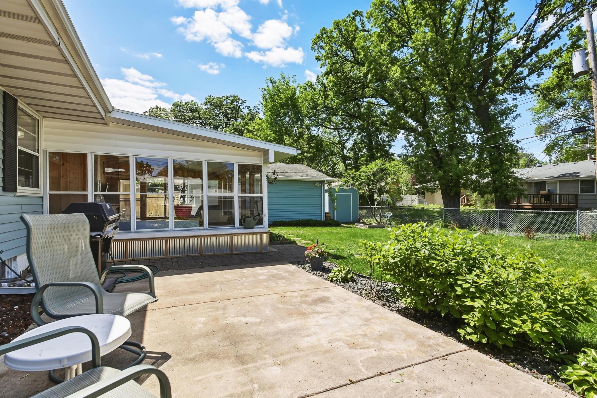 Fenced backyard, delightful patio area, gardens plus an outdoor storage shed..jpg