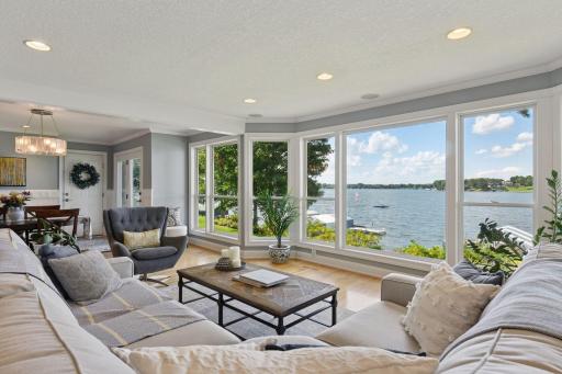 A wall of windows perfectly frames the scenic backyard, gardens, and sparkling waters of Lake Minnetonka.