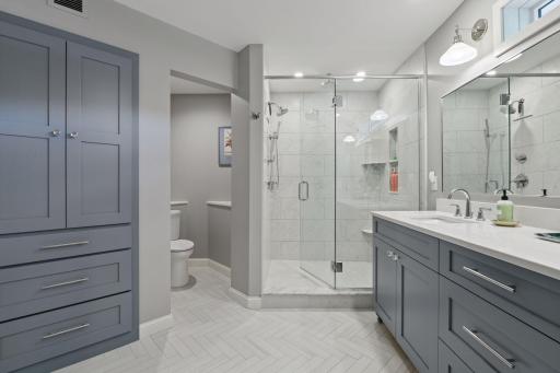 Premium shower & floor tile, new vanity, countertops, lighting and shower system.